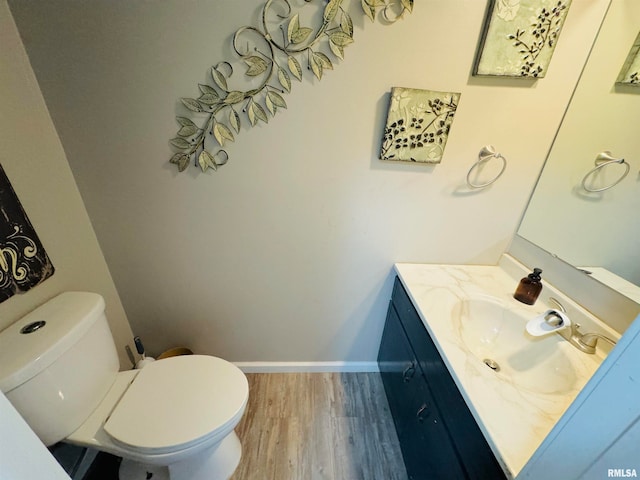 bathroom featuring hardwood / wood-style flooring, vanity, and toilet