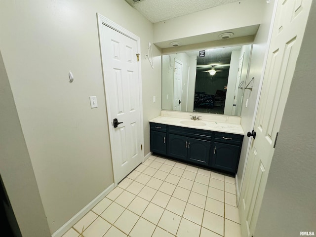 bathroom featuring ceiling fan, tile patterned flooring, and vanity