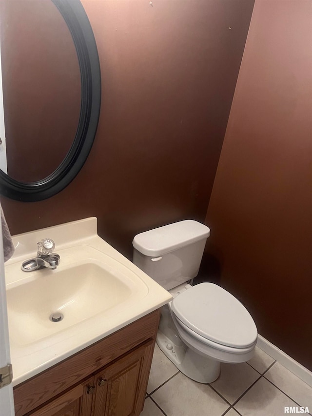 bathroom featuring vanity, tile patterned flooring, and toilet