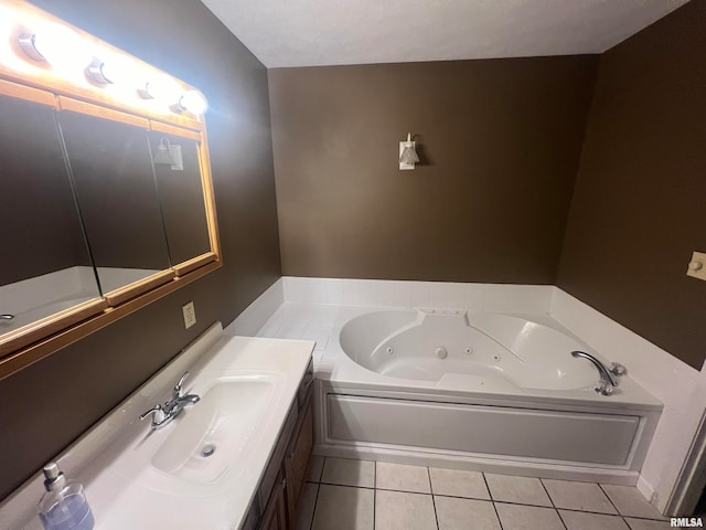 bathroom with tile patterned flooring, a tub, and vanity