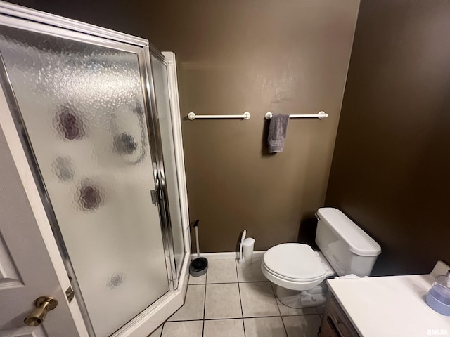 full bath with a shower stall, tile patterned flooring, baseboards, and toilet