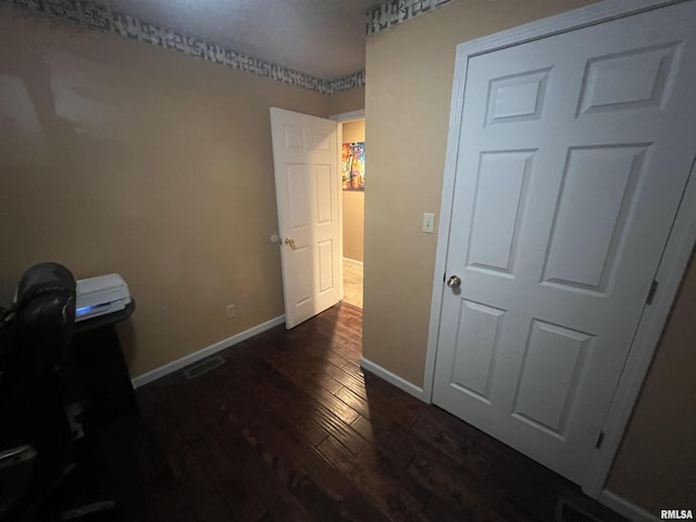 bedroom with visible vents, baseboards, and dark wood finished floors