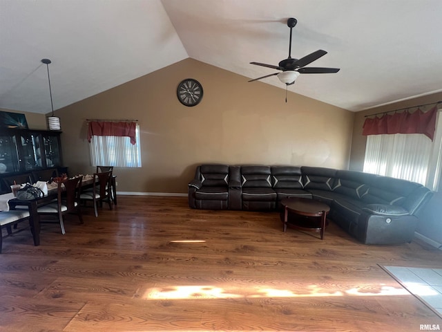 living room featuring ceiling fan, vaulted ceiling, and hardwood / wood-style floors