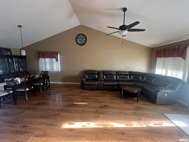 living area featuring wood finished floors, a ceiling fan, lofted ceiling, and a healthy amount of sunlight