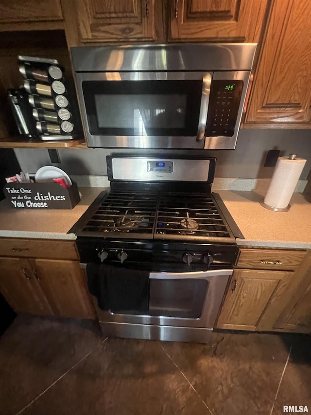 kitchen with stainless steel appliances, light countertops, and brown cabinetry
