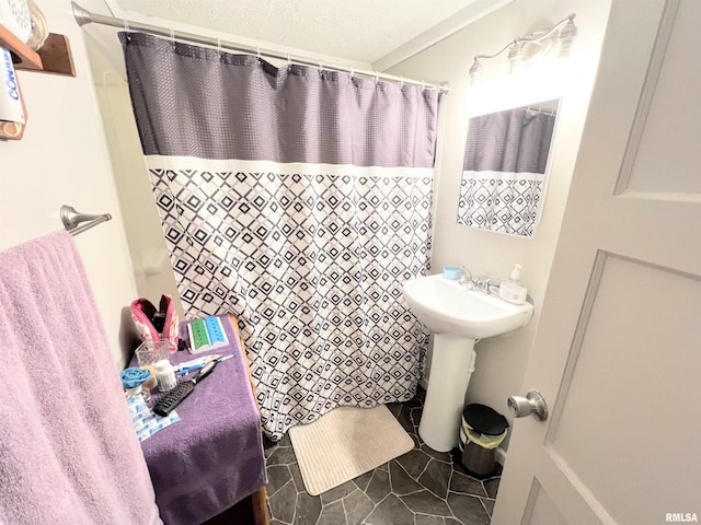 bathroom with sink, tile patterned flooring, a textured ceiling, and curtained shower