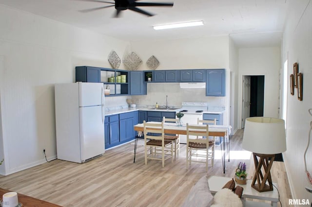 kitchen with blue cabinetry, light hardwood / wood-style flooring, and white appliances