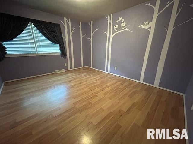 empty room featuring hardwood / wood-style floors