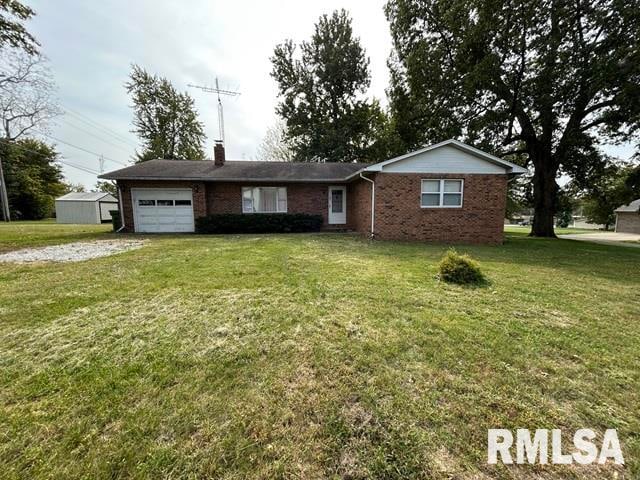 single story home featuring a garage and a front lawn