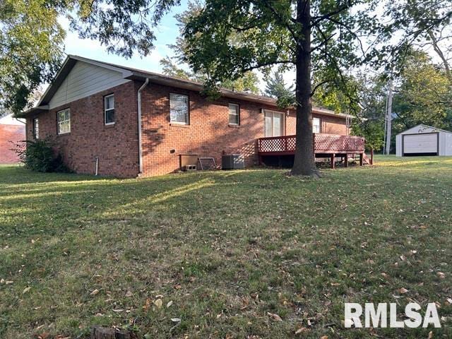 view of side of property featuring a yard and an outbuilding