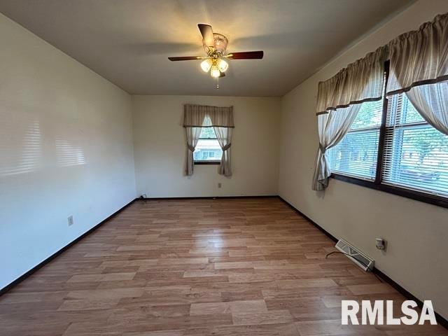 empty room featuring ceiling fan and hardwood / wood-style flooring