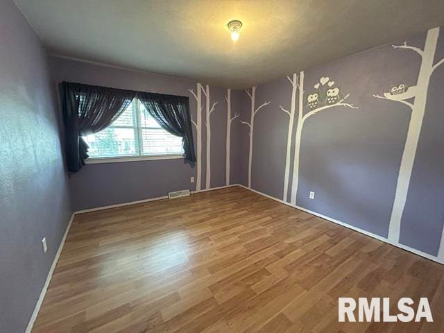 unfurnished room featuring hardwood / wood-style floors