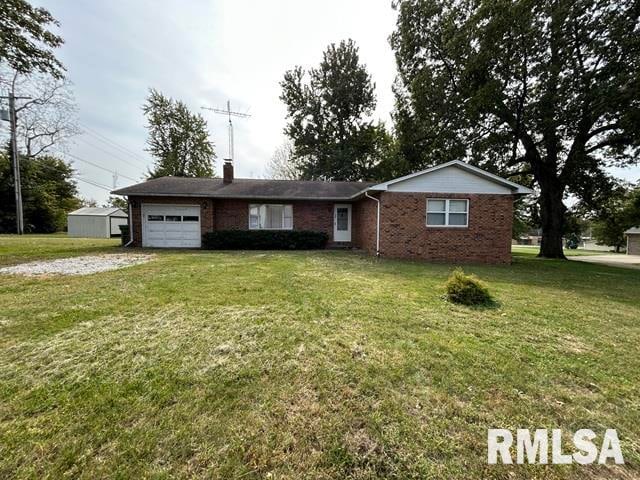 single story home with a front yard and a garage