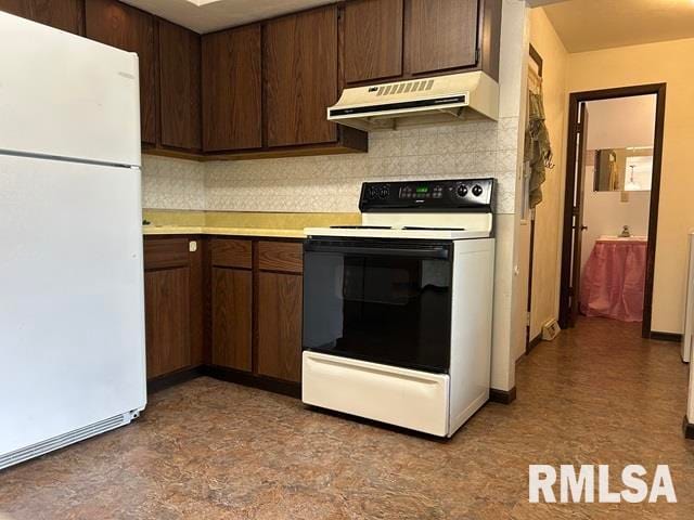 kitchen featuring decorative backsplash, white appliances, and dark brown cabinetry