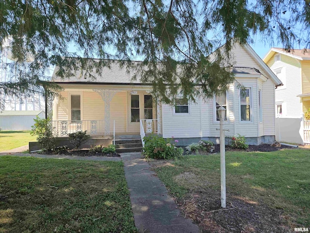 bungalow-style home with a front lawn and covered porch