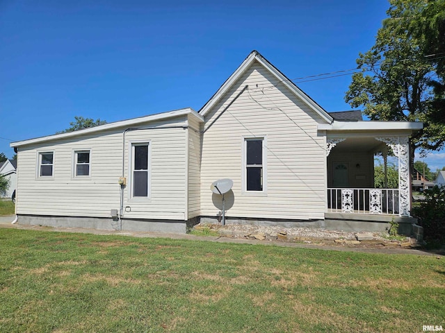 rear view of property featuring a yard