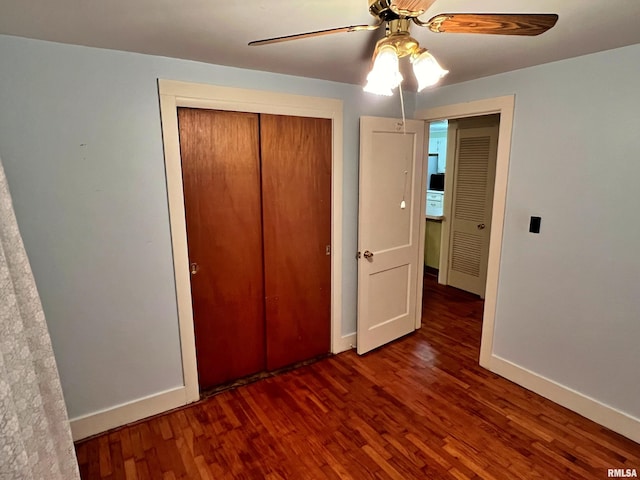 unfurnished bedroom with ceiling fan, a closet, and dark hardwood / wood-style floors