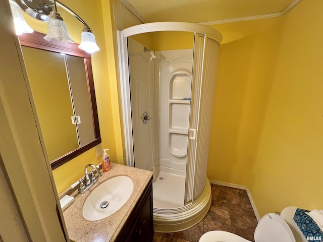 bathroom with crown molding, toilet, walk in shower, and vanity