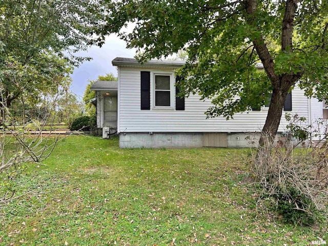 view of side of property with a yard