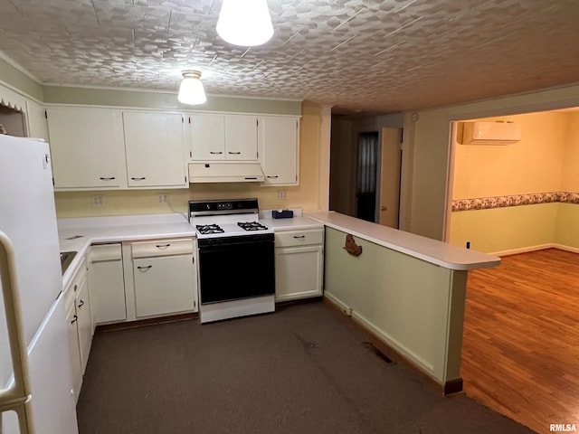 kitchen with white appliances, ventilation hood, white cabinetry, kitchen peninsula, and a textured ceiling