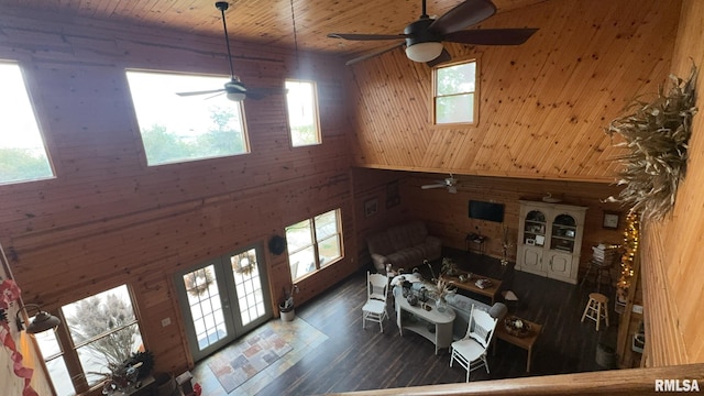 unfurnished living room featuring wood walls and a wealth of natural light