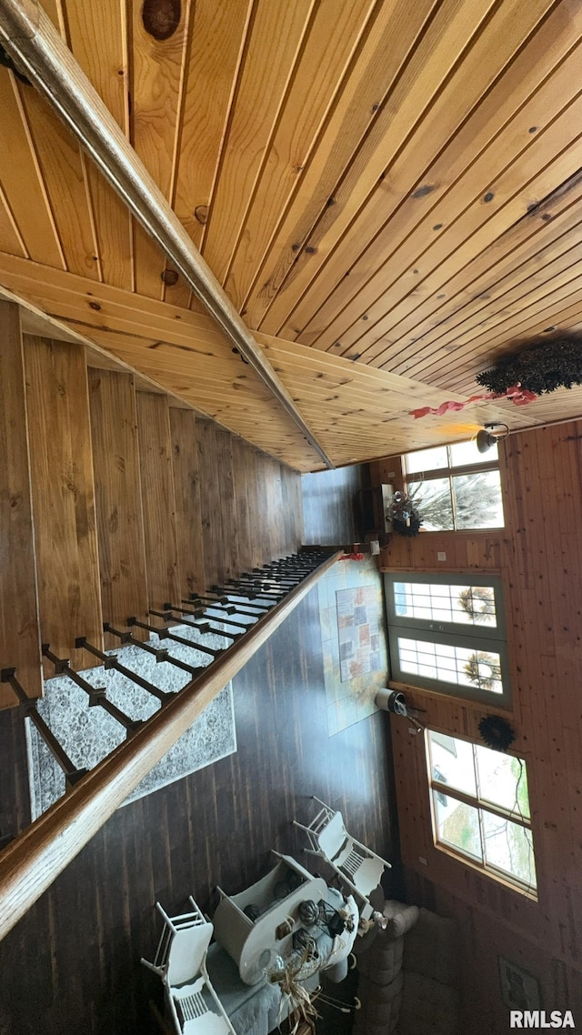 interior space featuring wood walls and wooden ceiling