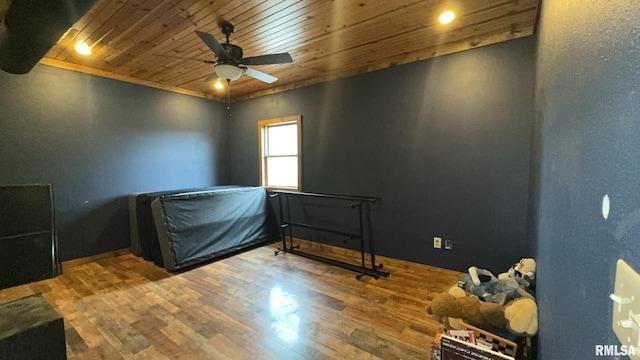 bedroom featuring hardwood / wood-style flooring, ceiling fan, and wood ceiling