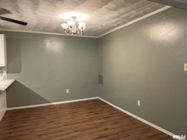 unfurnished dining area with ornamental molding, hardwood / wood-style flooring, and an inviting chandelier