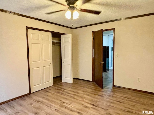 unfurnished bedroom featuring a textured ceiling, a closet, light wood-type flooring, and ceiling fan