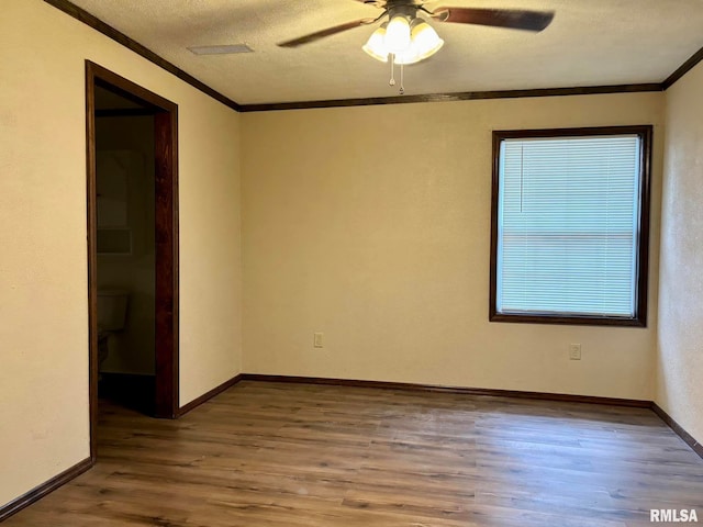 unfurnished room featuring ornamental molding, ceiling fan, and wood-type flooring