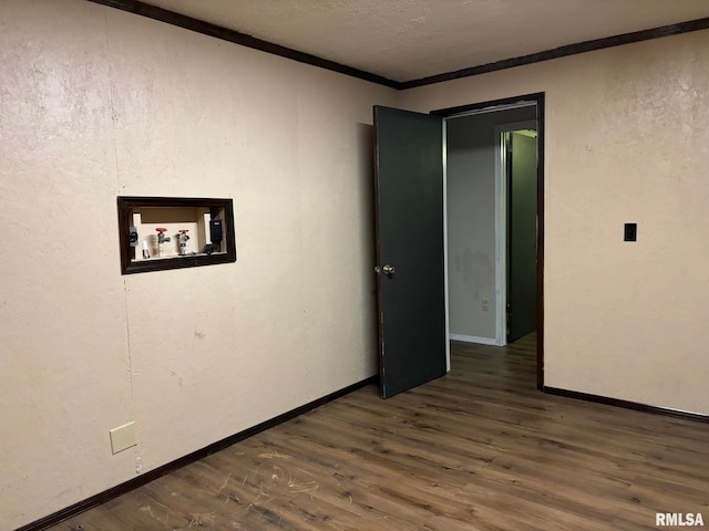 spare room with crown molding and dark hardwood / wood-style flooring