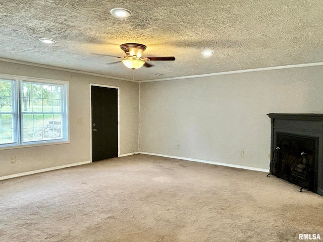 unfurnished living room with ceiling fan, ornamental molding, and carpet