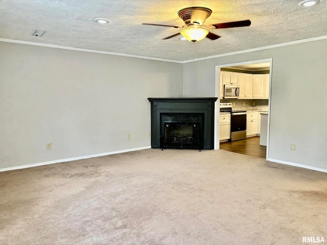 unfurnished living room with ceiling fan, crown molding, and a textured ceiling