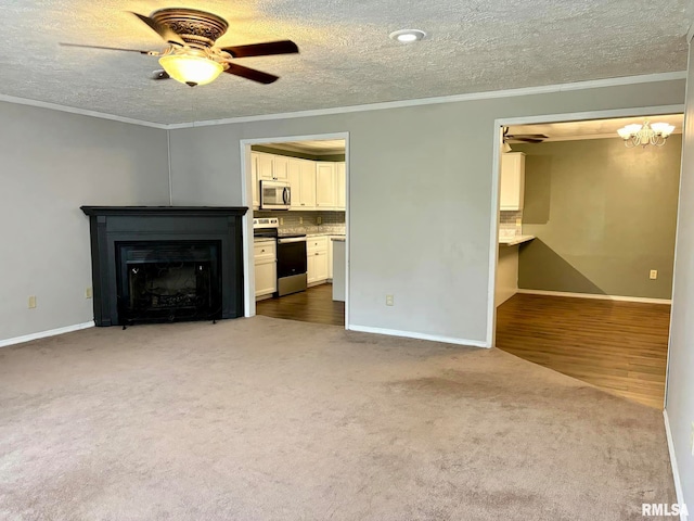 unfurnished living room featuring ornamental molding, hardwood / wood-style flooring, ceiling fan, and a textured ceiling