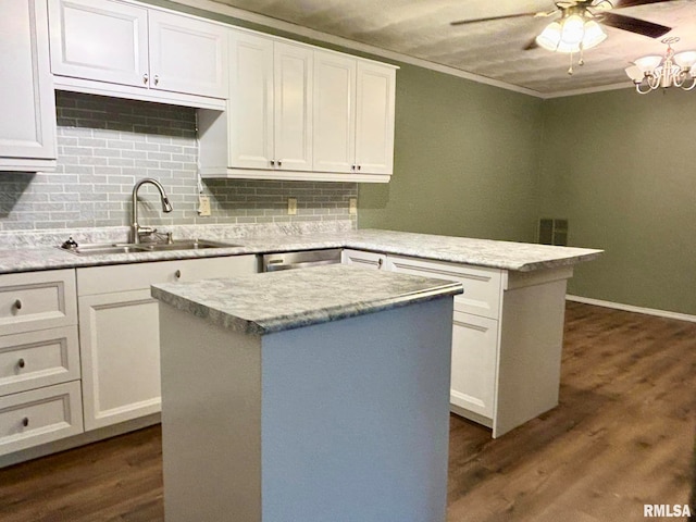 kitchen featuring a kitchen island, white cabinetry, and sink