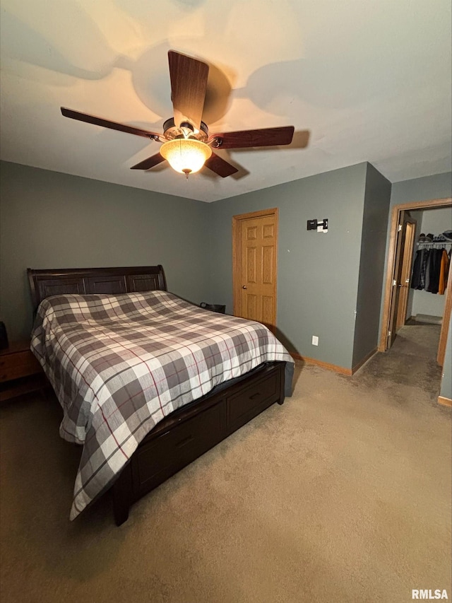 carpeted bedroom with a closet and ceiling fan