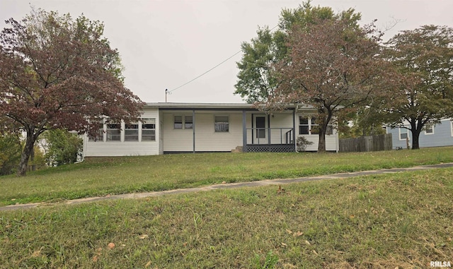 view of front of property with a front yard and covered porch