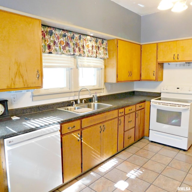 kitchen featuring white appliances, light tile patterned floors, and sink