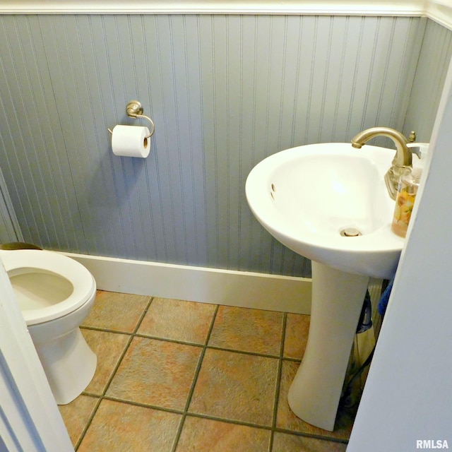 bathroom featuring toilet and tile patterned flooring