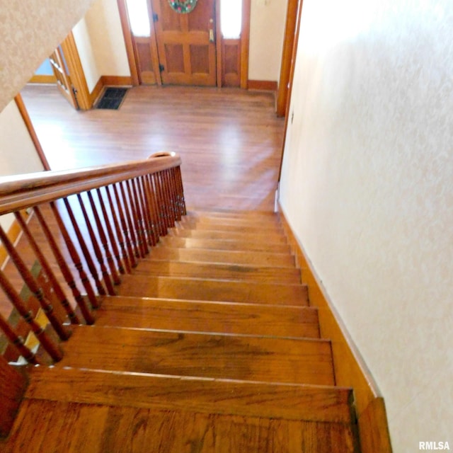 stairway with wood-type flooring