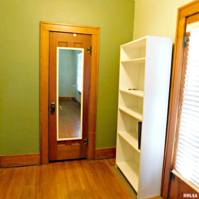 hallway with wood-type flooring