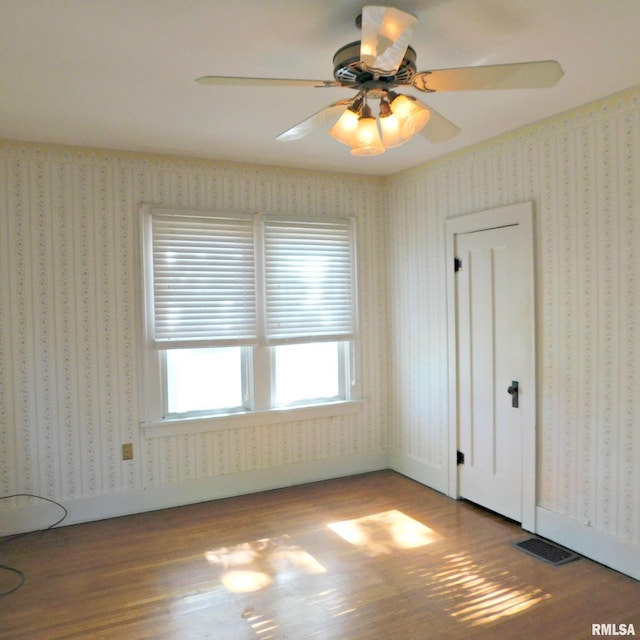 spare room with ceiling fan and wood-type flooring