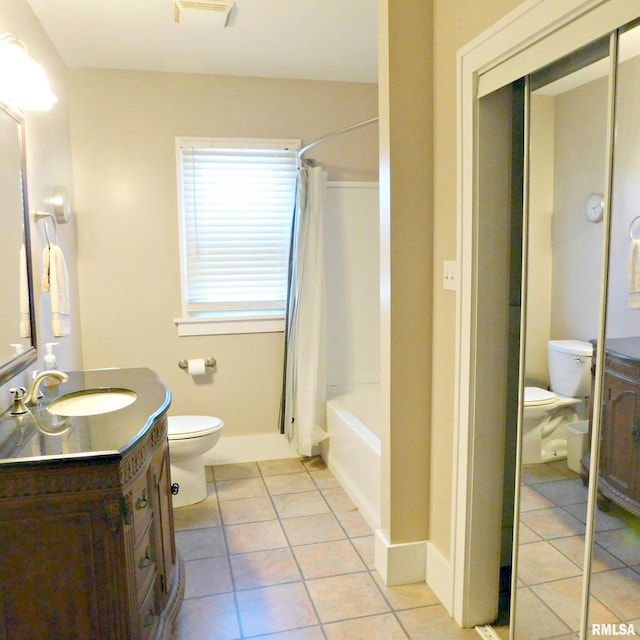 bathroom featuring vanity, toilet, and tile patterned floors