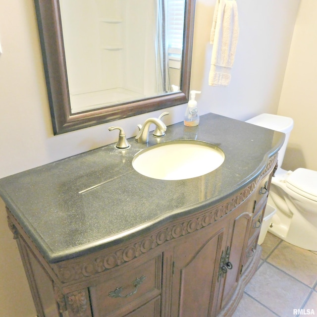 bathroom featuring vanity, toilet, and tile patterned flooring