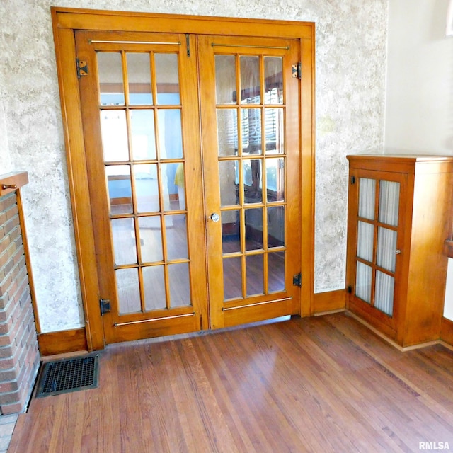 entryway featuring french doors and hardwood / wood-style flooring