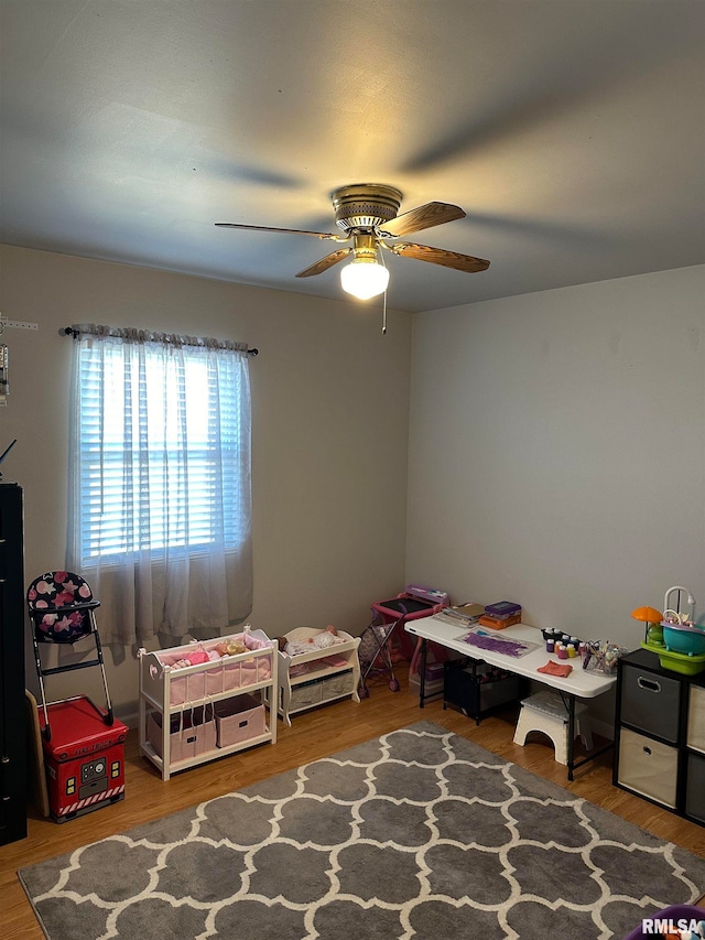 recreation room featuring wood-type flooring and ceiling fan