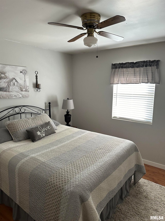 bedroom featuring ceiling fan and hardwood / wood-style flooring