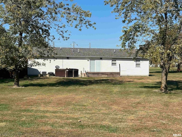 rear view of property with a yard