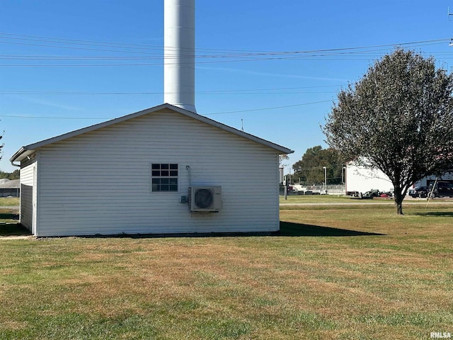 view of side of home with a yard and ac unit