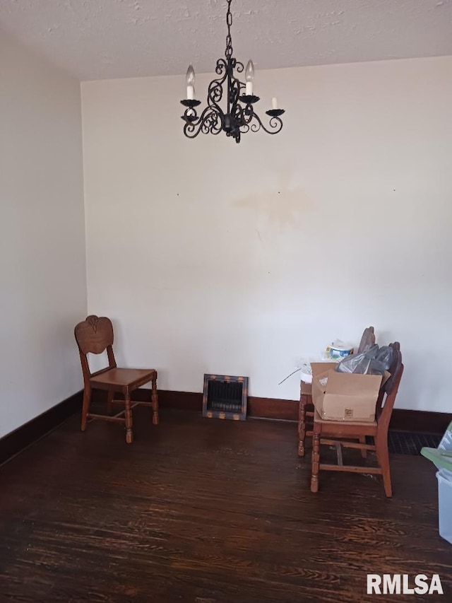 dining area featuring a textured ceiling and dark hardwood / wood-style flooring